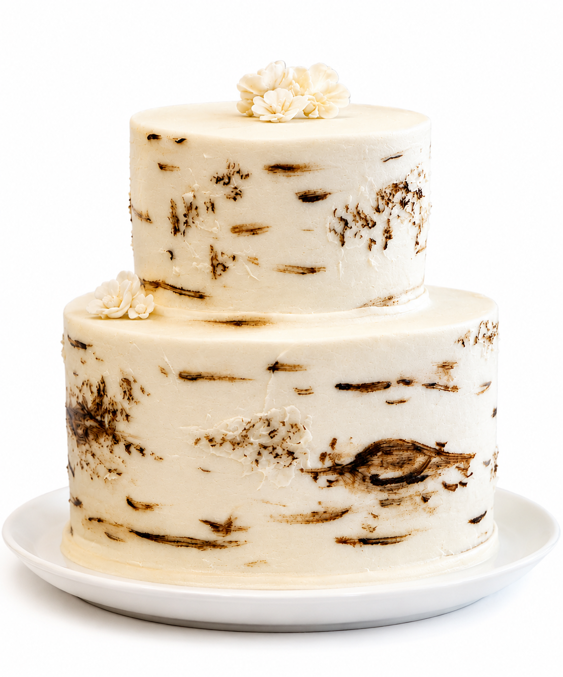 Two-tier cream birch bark cake with floral accents